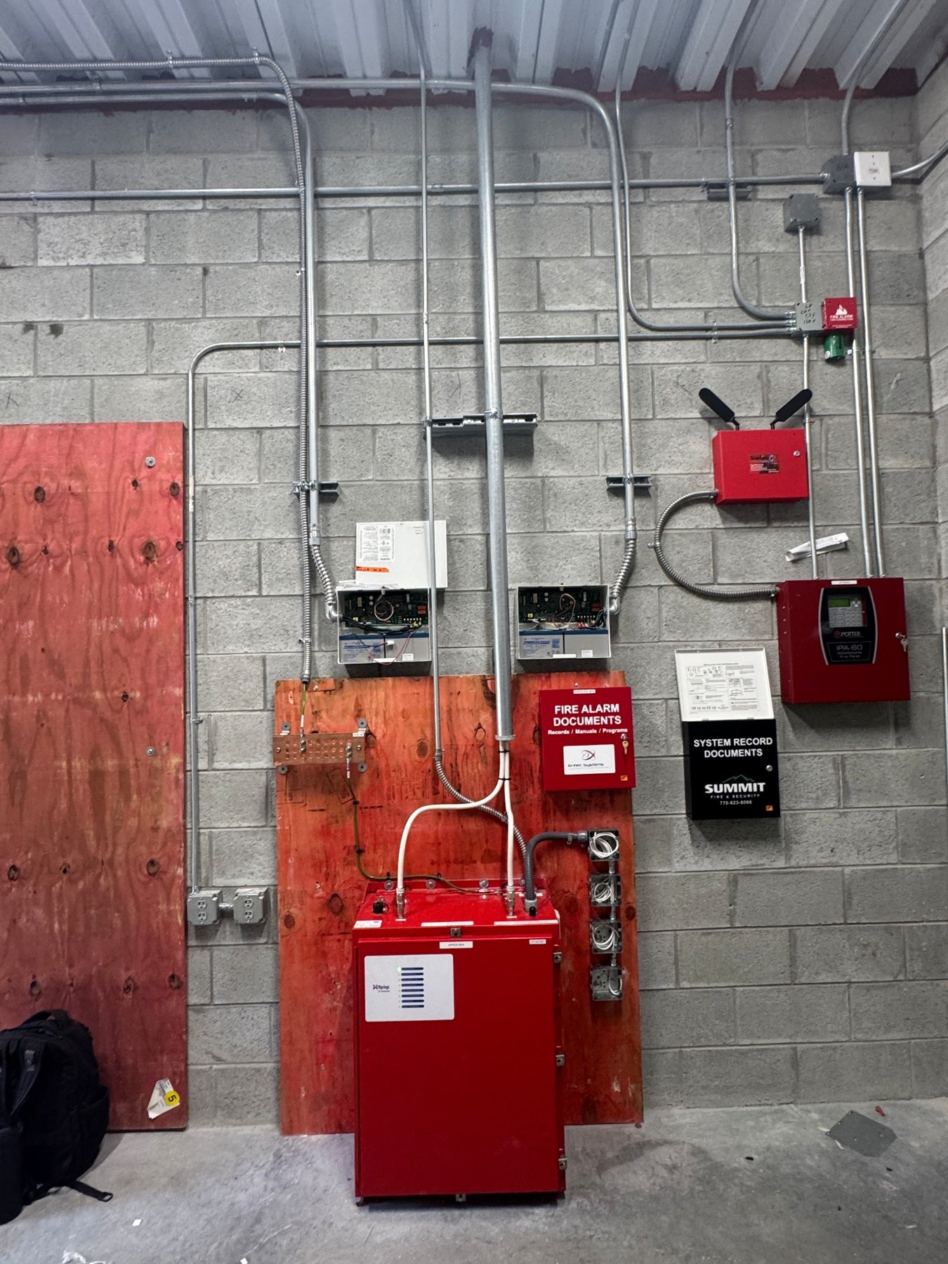 Public safety BDA equipment room with fire alarm interface equipment